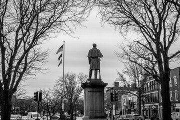 Statue of soldier facing the American flag in New Hampshire