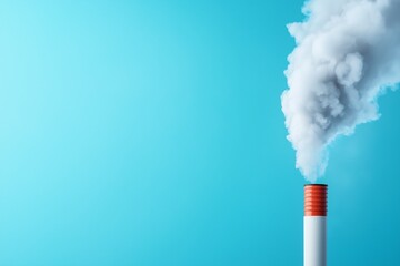 Industrial Pollution White Chimney Emitting Grey Smoke Against a Blue Sky Background