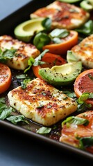 Grilled halloumi with avocado, tomatoes, and fresh basil garnish on a tray National Food Month