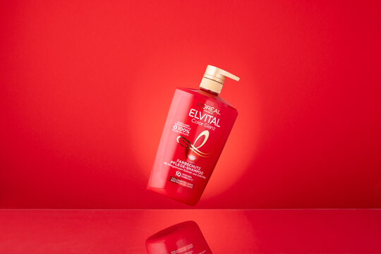 L'Or&eacute;al Paris Elvital Color Glanz Shampoo Floating over Red Background, a German Haircare Product