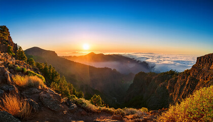 sun rising over caldera de taburiente with mist mountains caldera sunrise