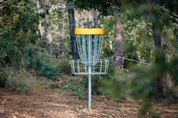 Frisbee Golf Target with Blurred Forest Background