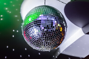 Colorful mirror disco ball at nightclub. Shiny sphere neon night light 