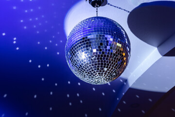 Colorful mirror disco ball at nightclub. Shiny sphere neon night light 