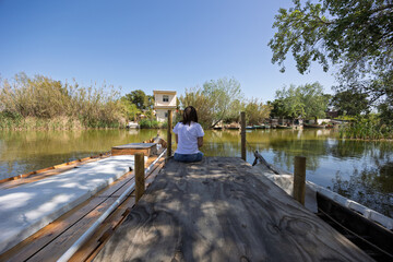 Tourist relaxing on pier at albufera natural park in valencia