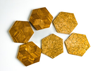 Six hexagon shaped hot pads isolated on white background. Three cork and three wooden