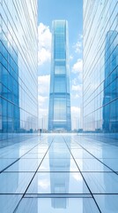 Fototapeta premium Tall glass skyscraper rises above mirrored buildings under a bright blue sky with wispy clouds