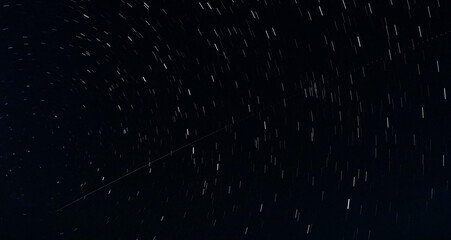 Star Trails and Airplane Trail in the Night Sky