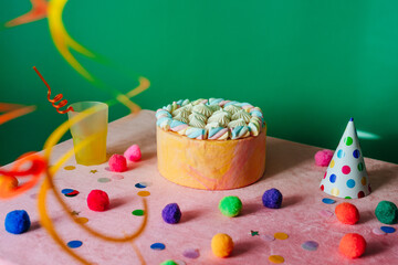 Birthday cake on the decorated table over green background