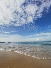 Tranquil Beach Waves and Blue Sky on a Sunny Day