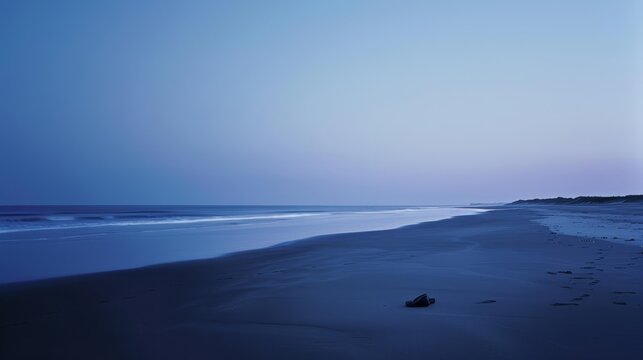 A vast, empty beach at twilight, the sky a gradient of deep blues and purples. In the foreground, a pair of shoes abandoned in the sand suggests a story left untold. The serene yet haunting atmosphere