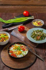 Set table, Jewish food, tzimmes, chelnt, shakshuka and couscous