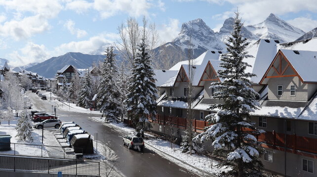Snowy Street Scene in Canmore, Alberta, with Mountain Peaks in the Background
