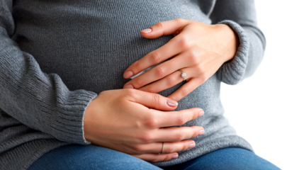 Expectant mother gently cradling her pregnant belly indoors