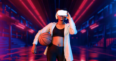 Basketball player holding basketball hologram at futuristic sport arena. Energetic athlete or sport...