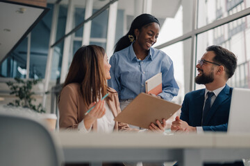 Business team discussing work in modern office environment
