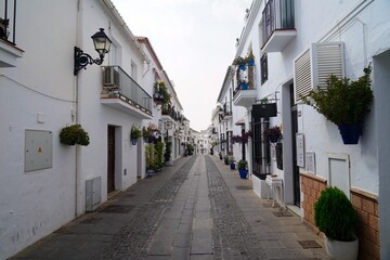 Fototapeta premium narrow street in the old town of Mijas, a historic town in the mountains of Andalusia between Marbella and Malaga, Fuengirola, Benalmádena, Costa del Sol, Spain
