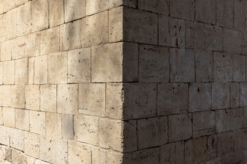 Photograph of the corner of a brick wall with stone blocks