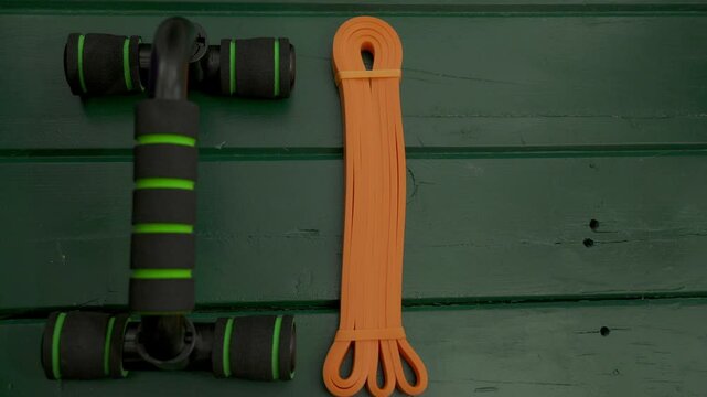 Fitness equipment for exercising at home, including rubber extenders and supports for bending.