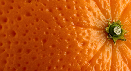Extreme close-up of a vibrant orange peel showcasing its textured surface