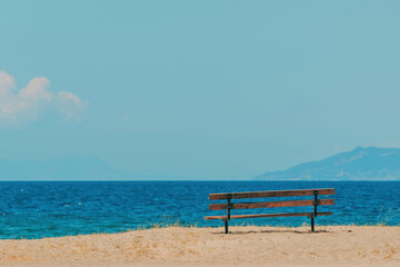 Empty bench at Aegean sea beach in summer