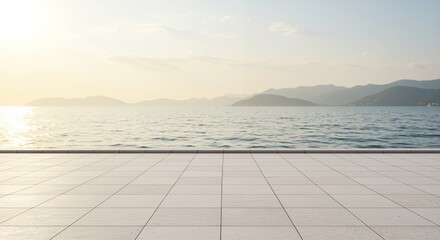 Sunlit coastal view with serene water surface and distant mountains, showcasing an expansive tiled terrace for relaxation