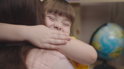 little girl daughter hugs her beloved mother. happy family. childhood dream life. child education of a small kid family. childhood in mother's arms. baby daughter love mommy. parent patronize child.