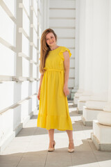 Full body portrait of a red-haired woman in yellow dress