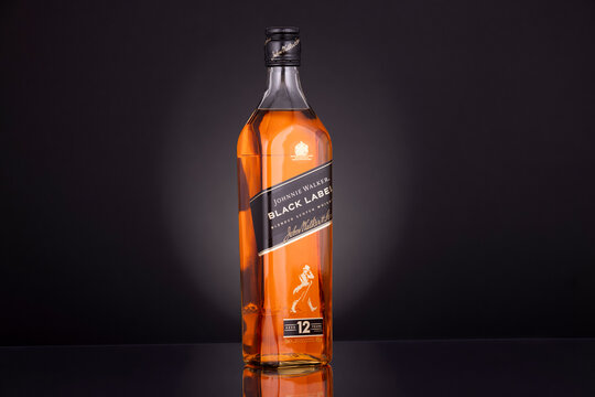 Studio Close-Up of Johnnie Walker Black Label 12 Year Old Scotch Whisky Bottle on Black Background &ndash; Premium Alcoholic Beverage Branding Image