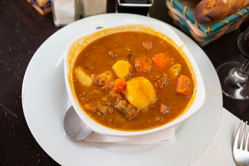 Stewed veal with lentils, potato and carrot with thick tomato sauce