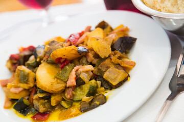 Image of dish from tasty fried different vegetables with bacon at white plate