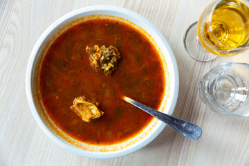 Traditional Caucasian food spicy Kharcho soup with lamb, tkemali and rice