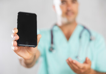 Doctor employs modern communication tools, using his phone to address medical inquiries.