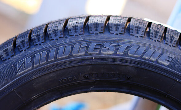Close-up of bridgestone tire textured tread pattern in outdoor setting