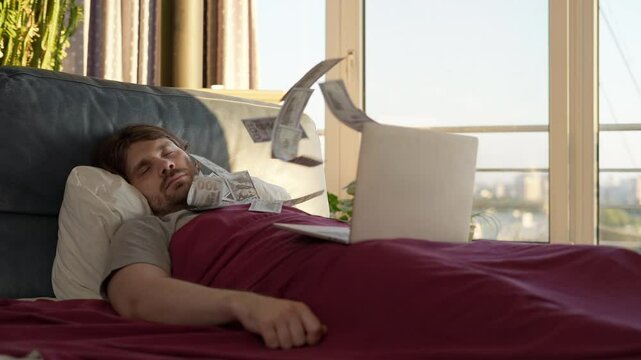 Man making money while sleeping in bed. Freelance investor awaking by a flow of money flying from laptop screen. Earning money in relax. Lazy man passive income, easy money concept. Crypto investment