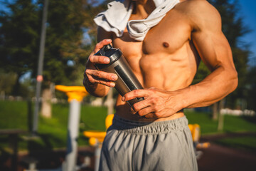 One caucasian man young male athlete take a brake during outdoor training in the park outdoor gym...