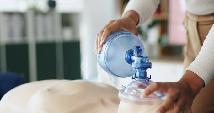 Ventilator, cpr and hands of woman with dummy for demonstration, tutorial and lesson for first aid. Healthcare, safety and person with respiratory mask for paramedic course, learning or medical class