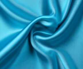 Obraz premium Wrinkled blue satin fabric with a glossy surface for textile visuals, luxury branding, or elegant digital mockups