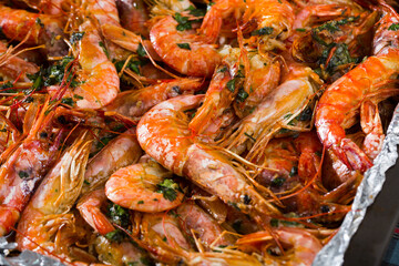 Dish of Mediterranean cuisine - baked in oven tiger shrimps with herbs