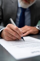 A corporate executive concluding a deal by endorsing a legal agreement.
