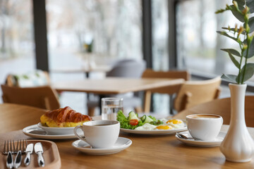 Delicious breakfast served on wooden table in cafe