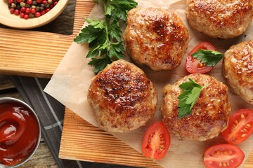 Delicious patties, spices, tomatoes and ketchup on table, flat lay