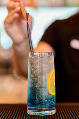 Blue Curacao Cocktail with lemon and ice in a glass