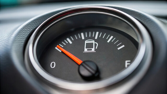 Fuel gauge shows stagnation in economy as it approaches empty, indicating need for refueling soon