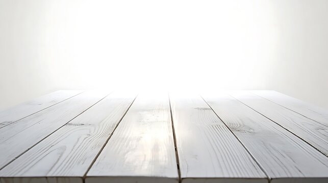 A bright and evenly lit empty white wooden table top, captured from a front angle with a shallow depth of field.
