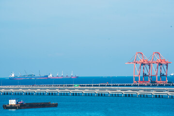 Logistic shipping quay boat Engineering crane depot at logistic export terminal control. Warehouse freight background container yard loading quayside harbor port. Logistics seascape shipping portal