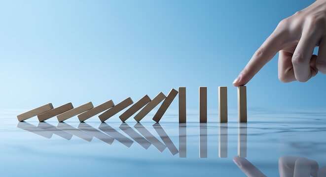 Finger Starting Domino Effect with Wooden Blocks on Blue Surface