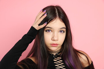 Teenage girl posing on pink background. Makeup and clothes in anime style