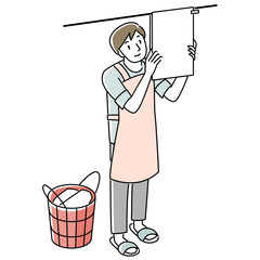 洗濯物を干すエプロンを着けた男性