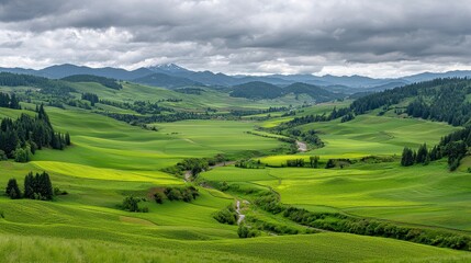Lush Green Valley Under Dramatic Sky, Rolling Hills and Distant Mountains